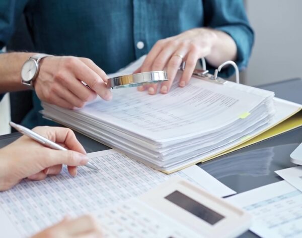 Business,Colleagues,Reviewing,Financial,Documents,And,Calculating,Taxes.,Auditor,Inspecting