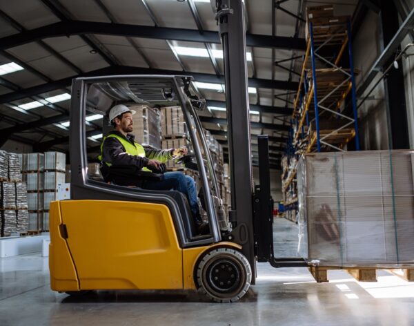 Side,View,Of,Forklift,In,Warehouse,With,Male,Driver.,Warehouse